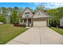 Charming two-story home with stone accents, a covered porch, and a two car garage at 190 Bingham Creek Dr, Garner, NC 27529