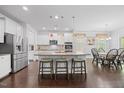 Bright, modern kitchen with a large island, stainless steel appliances, and a dining area at 190 Bingham Creek Dr, Garner, NC 27529