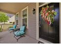 Inviting porch with comfortable seating and a decorative wreath on the front door at 190 Bingham Creek Dr, Garner, NC 27529