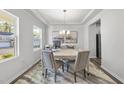Bright and inviting office space featuring a modern chandelier and a large window with natural light at 20 Carolina Maple Dr, Franklinton, NC 27525