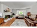 Bright living room with fireplace, hardwood floors, and a comfortable seating area at 201 Dunhagan Pl, Cary, NC 27511