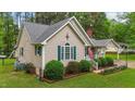 Exterior showcasing lush greenery, manicured lawn, and well-maintained home at 2024 Country Trails Dr, Clayton, NC 27520