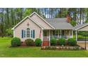 Inviting home exterior with neat landscaping and a welcoming front porch at 2024 Country Trails Dr, Clayton, NC 27520
