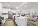 Modern kitchen featuring an island, stainless steel appliances, and an open layout at 205 Fig Tree Bnd, Zebulon, NC 27597