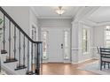 Bright foyer with hardwood floors, staircase, and views into other rooms at 2109 Hemlock Hill Dr, Durham, NC 27703