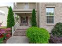 Inviting front porch with brick steps, decorative shrubbery, and charming exterior details at 2109 Hemlock Hill Dr, Durham, NC 27703