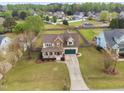 Charming home with a well-manicured lawn and a long driveway at 2113 Conroy Way, Willow Springs, NC 27592