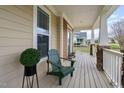 Inviting front porch with comfortable seating and decorative potted plants at 2113 Conroy Way, Willow Springs, NC 27592