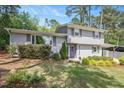 Charming two-story home with a well-maintained lawn, gray brick, and a purple front door at 2120 Hillock Dr, Raleigh, NC 27612