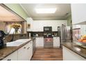 Bright kitchen featuring stainless steel appliances, updated countertops and flooring at 2124 Castle Pines Dr, Raleigh, NC 27604