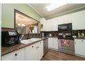 Modern kitchen with stainless steel appliances, granite countertops, and white cabinetry at 2124 Castle Pines Dr, Raleigh, NC 27604