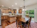 Well-equipped kitchen with stainless steel appliances, center island, and a dining area filled with natural light at 2125 Toad Hollow Trl, Apex, NC 27502