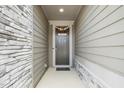 Welcoming front door with festive decorations and a sidelight, framed by stone and siding accents for added curb appeal at 2129 Mars Hill Ln, Apex, NC 27502