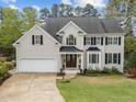 Charming two-story home with manicured lawn, black shutters, and a covered porch at 213 Lewiston Ct, Cary, NC 27513