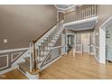 Bright foyer with hardwood floors, staircase with white railings, and neutral wall paint at 213 Lewiston Ct, Cary, NC 27513