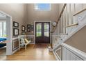 Welcoming foyer with hardwood floors, a staircase, and a decorative double door entry at 213 Lewiston Ct, Cary, NC 27513