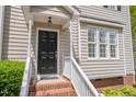 Close-up of the front door, showcasing the black door, white trim, and brick steps at 22 Lure Ct, Durham, NC 27713