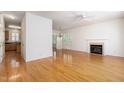 Open-concept living space featuring hardwood flooring, a fireplace, and an elegant chandelier at 22 Lure Ct, Durham, NC 27713
