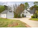 Spacious backyard featuring a detached garage and a well-maintained lawn at 2404 Gillingham Dr, Apex, NC 27539