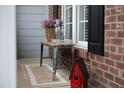 Charming front porch decor with a Welcome sign, flowers, and a bunny figurine at 2404 Gillingham Dr, Apex, NC 27539