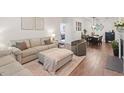 Open-concept living area shows sofa, fireplace, and dining space, bathed in natural light at 2651 Mellow Field Dr # 206, Raleigh, NC 27604