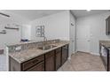 Kitchen view featuring granite countertops, stainless steel sink, and tile flooring at 2705 Evanston Ave, Durham, NC 27703