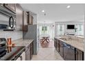 Bright kitchen featuring granite countertops, stainless steel appliances, and tile flooring at 2705 Evanston Ave, Durham, NC 27703