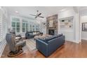 Comfortable living room with stone fireplace, built-in shelves, and large windows providing natural light at 2832 Thompson Bluff Dr, Cary, NC 27519
