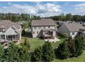 Aerial view of backyard featuring a patio, deck, fenced yard, and mature trees at 2905 Pluton Pl, Rolesville, NC 27571