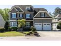 Charming two-story home with a neatly maintained lawn and attached two-car garage at 2905 Pluton Pl, Rolesville, NC 27571