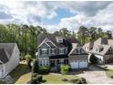 Beautiful two-story home nestled on a tree-lined street, showcasing a spacious yard and attached garage at 2905 Pluton Pl, Rolesville, NC 27571