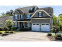Lovely two-story home boasts an attached two-car garage, driveway, and lush landscaping at 2905 Pluton Pl, Rolesville, NC 27571