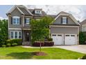 Stunning two-story home boasts an attached two-car garage and a meticulously maintained lawn at 2905 Pluton Pl, Rolesville, NC 27571