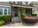 Inviting front porch with stone steps, decorative columns, and lush landscaping at 2905 Pluton Pl, Rolesville, NC 27571