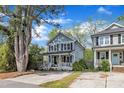 Charming two-story home with a welcoming porch and a bright yellow front door at 3 Maple St, Raleigh, NC 27610