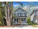 Charming two-story home with a welcoming porch and a bright yellow front door at 3 Maple St, Raleigh, NC 27610