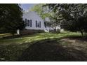 Landscaped front yard showcasing a well-maintained lawn and beautiful mature trees at 300 Round About Rd, Holly Springs, NC 27540