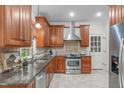 Well-equipped kitchen featuring custom cabinets, granite countertops, and stainless steel appliances at 307 Parkmeadow Dr, Cary, NC 27519