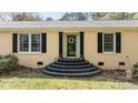 Close-up of the front entrance, featuring elegant steps and a decorative front door with black door frame at 310 Edward Ln, Louisburg, NC 27549