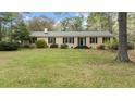 Charming single-story home with symmetrical design, black shutters, and a green front lawn at 310 Edward Ln, Louisburg, NC 27549