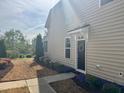 Charming home featuring a black front door adorned with a wreath and colorful landscaping at 318 Acorn Hollow Pl, Durham, NC 27703