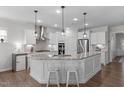 Bright kitchen with stainless steel appliances, granite countertops, and a breakfast bar at 3262 Ripley River Rd, New Hill, NC 27562