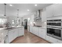 Gourmet kitchen featuring stainless steel appliances, double oven, granite countertops, and a center island at 3262 Ripley River Rd, New Hill, NC 27562