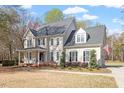 Charming two-story home with a welcoming front porch and mature trees at 3908 Yateswood Ct, Raleigh, NC 27603