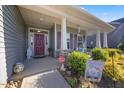 Inviting front porch with decorative columns and a well-maintained garden at 405 Club Center Dr, Youngsville, NC 27596