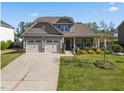 Charming two-story home with a three-car garage and well-manicured front yard at 405 Club Center Dr, Youngsville, NC 27596