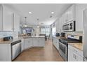 Open concept kitchen with stainless appliances, granite countertops and adjacent dining area at 405 Club Center Dr, Youngsville, NC 27596