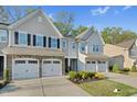 Beautiful townhome featuring stone accents, two-car garage, and well-manicured landscaping at 425 Summit Trail Dr, Hillsborough, NC 27278