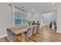 Elegant dining room boasts hardwood floors, natural light, and stylish seating, great for entertaining at 4905 Abundance Ave, Raleigh, NC 27616