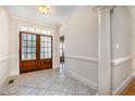 Bright foyer features tile floors, wooden double-doors, and elegant molding; offering a welcoming entrance at 502 Sippihaw Oaks Dr, Fuquay Varina, NC 27526
